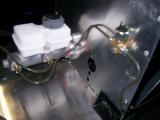 The smallest brake line coming from the master cylinder into the other T-piece. Then the longest brake line beginning its journey to the rear of the car through the transmission tunnel, on the opposite side to the fuel lines