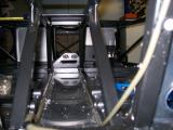 View from the rear of the car showing the brake line's path down the drivers side of the transmission tunnel, with both fuel lines on the left
