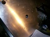 I had to enlarge this hole slightly to gain access to the wishbone bolt. I filed it down afterwards to smooth it.