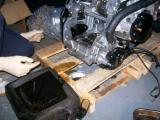 Bolts removed to expose the inside of the engine.