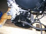 Cover in place covering chain sprocket and clutch mechanist