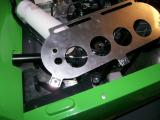 The air filter plate with holes cut and clips fitted.